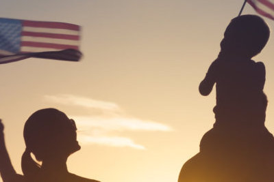 family holding USA flag