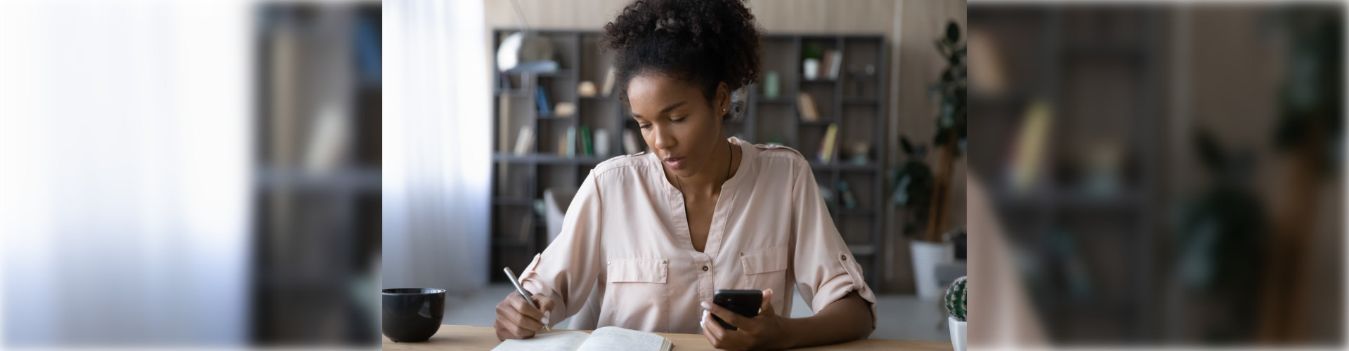 black woman with phone and notebook